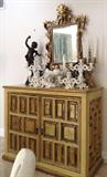 Mexican Wood Cabinet with Raised Panel Mirror Decor & Gilding; Carved and Gilded Framed Beveled Mirror; Figural Candelabra and Vessel