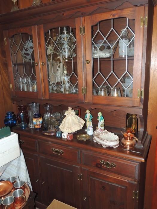 vintage china cabinet filled with 1950's glassware set including bar set and decanters