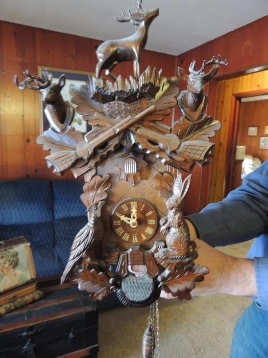 Cuckoo clock with stags and rifles, made in Germany. Good working condition