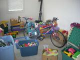 Bicycle, Small childrens tables, Bins full of toys.