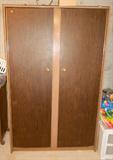 Vintage metal cabinet for hanging clothes.