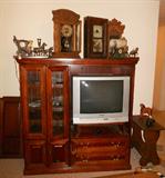 Nice entertainment center. United Covered wagon Clocks, Gingerbread Clocks, Antique Clocks. Panasonic Surround Sound Television.