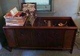 Magnavox Console Stereo Cabinet and working turntable. This is just one of several stacks of record albums. Also 45's - see other photo.