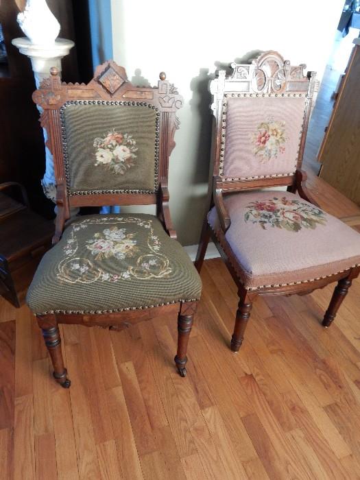 A pair of Victorian Side Chairs each has crewel seats and backs.
