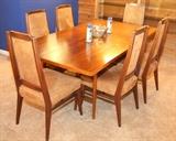 Mid-century dining room table with 2 leaves and 6 chairs.