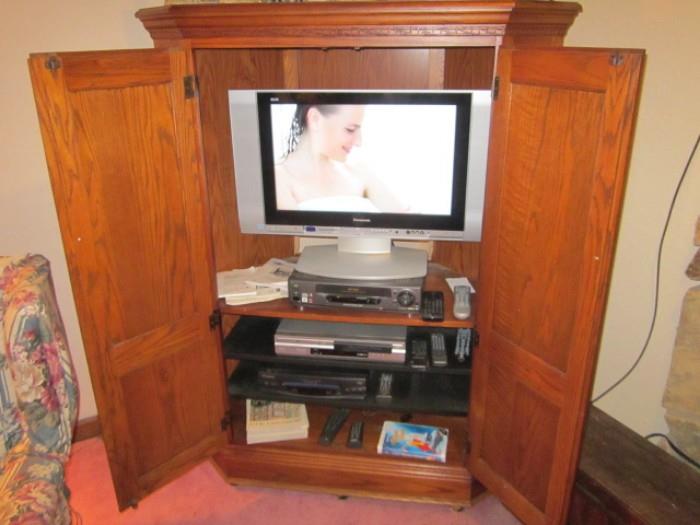 Entertainment center, flat screen Panasonic tv, and two DVD, Cassette players, all in good working order.