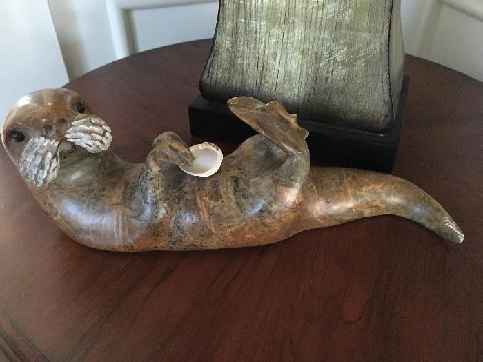 This stone carved otter is a playful piece of art