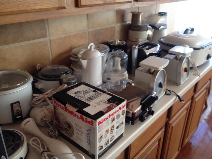 Huge collection of small kitchen appliances - roaster, chopper, mixers, kitchen aid parts, steamer, scales, meat slicer.
