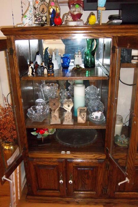 Armoire with glass and wolf sculptures