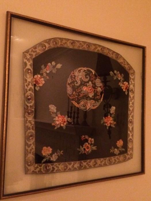 antique asian textile/sleeve floating in a frame