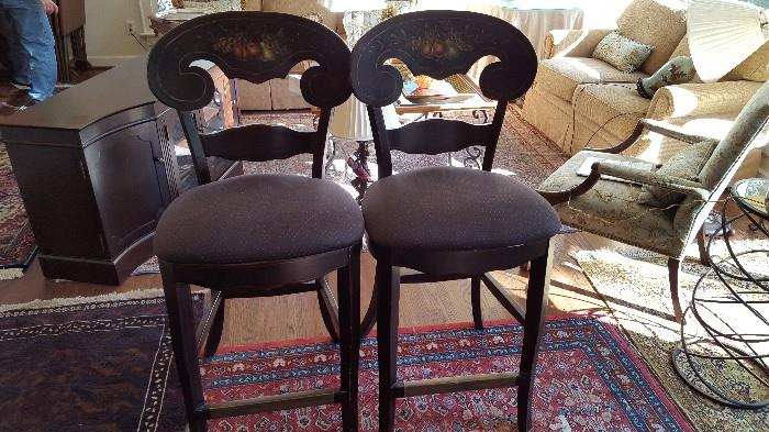 two wooden floral painted bar stools
