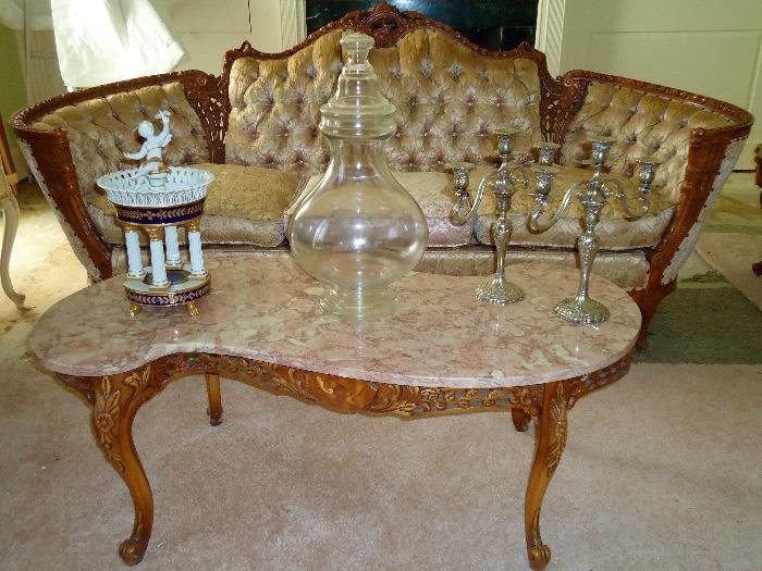 Italian carved and tufted brocade sofa, marble top Italian marquetry coffee table, Dresden porcelain, silver plated candlabras
