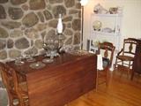 Walnut drop leaf table and three chairs of the set of five