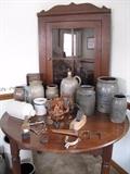 Hanging corner cupboard, assorted crocks, and antique table