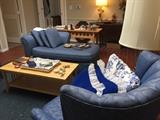 Blue chaise and blue channel back chair, Mission coffee table, lamps, decoratives