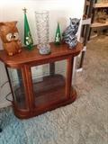 Short solid wood curio cabinet with inside lighting and curved glass front. Has 2 shelves inside.