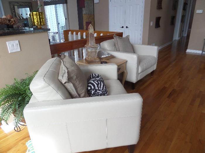 LEATHER SOFA'S, brand is Bloomindales.  Leather is soft and supple. Spotlessly clean.  Color is a soft white. Seen above is the pair of arm chairs.  
