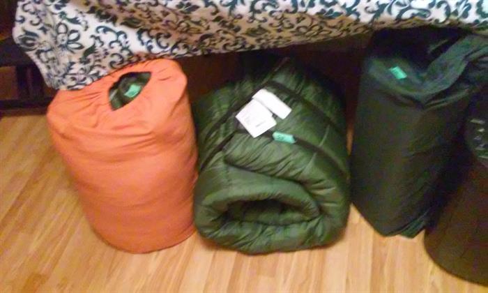 Camping Sleeping Bags and Duffle Bags and Roll up Cushion.