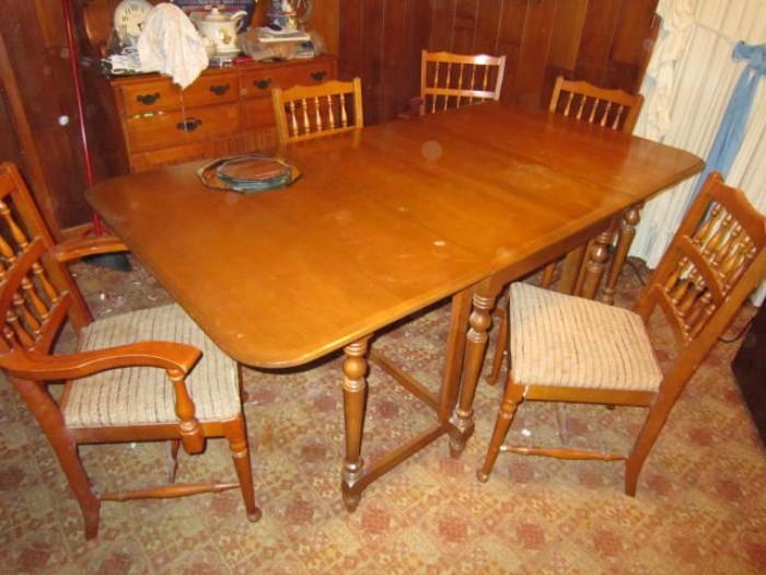 Drop leaf kitchen table with 4 chairs-2 more are available but need repair.