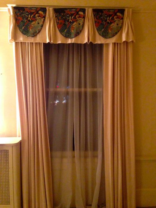 Four windows of custom silk white backed drapes and valances.