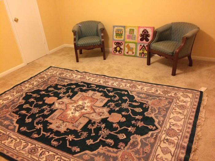 One of several vintage rugs, hotel room chairs, and nursery crafted artwork.