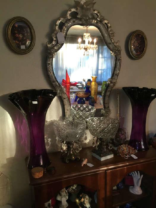 While the vintage mirror is wonderful don't overlook the pair of tall purple glass vases.