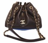 AUTHENTIC CHANEL brown leather drawstring shoulder bag in excellent condition. Brown leather exterior trimmed with gold hardware and woven chain and leather shoulder straps. Top drawstring style closure opens to a brown nylon lined interior that holds a matching brown leather pouch. This piece is in excellent condition. No stains, smells, or scuffs. Clean corners, edges, and interior. This piece is perfect for daily use as it comfortably carries all your essentials in classic Chanel style. The versitle drawstring design and brown leather coordinate wonderfully with any wardrobe choice in any season.
Purchase includes a dust cover.
Measurements: 11"x8.5"x4" 13.5" strap drop

Free shipping for this item within the continental US.