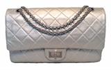 AUTHENTIC CHANEL silver leather jumbo double flap classic in excellent like-new condition. Light silver quilted leather exterior trimmed with matte silver hardware. Mademoiselle style twist closure opens double flap style to a matching silver leather lined interior that holds 3 slit, 1 lipstick, and 1 zipped "love note" pockets. This piece is in excellent condition. No stains, smells, or scuffs. Clean corners, edges, and interior. Chanel classic flap bags are some of the most coveted fashion accessories around the globe and this piece is no exception. The limited edition pale silver color is perfect for any occasion in any season while the timeless design carries all of your belongings in classic Chanel style. 
Purchase includes a dust cover, Authenticity card and manufacturers papers and Chanel box
Measurements: 12"x7.5"x3.75" 10.5-19" strap drop