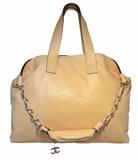 Chanel Buttery Beige Lambskin Weekend Shoulder Bag Tote in excellent condition. Soft beige lambskin leather exterior trimmed with silver hardware and CC logo stitched along the front side. Double leather handle straps and an additional woven leather and chain shoulder strap to wear a multitude of ways. Top snap closure opens to a slate grey satin lined interior that holds a strap key holder, one side zippered pocket, and 1 slit pocket. This piece is in excellent condition. No stains, smells or scuffs. Clean corners, edges, and interior. This piece is perfect for work or play as it comfortably carries all your belongings in classic Chanel style. The soft neutral beige color coordinates wonderfully with any wardrobe choice and will surely last a lifetime. Purchase includes a dust cover.
Measurements: 20"x16"x5" 9" handle drop 14" strap drop

Free shipping for this item within the continental US.