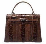 GORGEOUS LORENZI ostrich leather kelly bag in excellent condition. Brown ostrich leather exterior trimmed with shining silver hardware and lock with clochette and key. Black leather lined interior holds 1 slit, 1 zip, and 1 cell phone pocket along with plenty of space for all your essentials. This piece is in excellent condition. No stains, smells, or scuffs. Clean corners, edges, and interior. Perfect for the fashion lover looking for a rare exotic kelly bag without the extreme price tag. The brown ostrich leather also coordinates effortlessly with any wardrobe choice and will only increase in value throughout the seasons. 
Purchase includes a dust cover.
Measurements: 11"x8.25"x4" 3.5" handle drop

Free shipping for this item within the continental US.