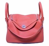 Absolutely Stunning Authentic Hermes Rose Jaipur lindy bag in excellent condition. Limited edition Rose Jaipur clemence leather exterior trimmed with shining palladium hardware. Two side slit exterior pockets for added storage. Double handles to carry or attached shoulder strap to wear depending on your preference. Top double zipper closure opens through a twist lock to a gorgeous vibrant pink leather interior that holds 2 side slit pockets and ample storage space for your belongings. This piece is in excellent NWOT condition. No stains, smells, or scuffs. Clean corners, edges, and interior. Perfect for adding a pop of color to any wardrobe. Purchase includes original box, dust cover, and raincoat. 
Measurements: 12"x6"x8" 4" handle 11" strap

Free shipping for this item within the continental US