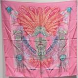 Gorgeous AUTHENTIC HERMES Mexique silk scarf in excellent condition. Original silk screen design c.1985 by Cathy Latham features a beautiful historical native american statue figure with a vibrant feathered head dress over a brightly colored background. 100% silk, hand rolled hem, made in France. Original tag attached. No stains, smells, or fabric pulls. Absolutely stunning design. This is a very rare colorway on a limited edition design that adds a bright pop of color to any wardrobe. Perfect for collectors and Hermes lovers.Purchase includes Hermes scarf box. Measurements: 35''x35'' = 90cm

Free shipping for this item within the continental US.