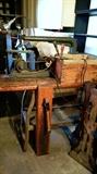 very cool antique scroll saw on what seems to be homemade wood and metal bench with vise.  sold all together    garage