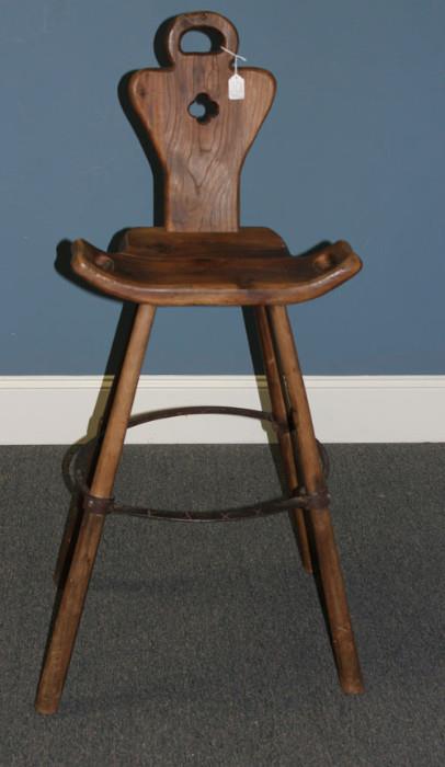Antique Birthing Stool or Chair. The sides have  handles and the back for support. There are four legs connected by a metal bar, with place for feet in the front.