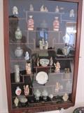Snuff bottles, cloisonne items, oriental carvings. Rosewood display cabinet.