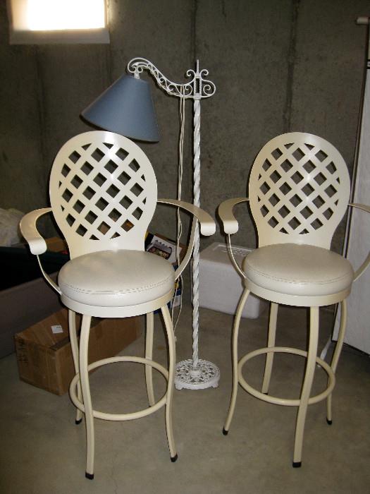 Metal bar stools and wrought iron floor lamp