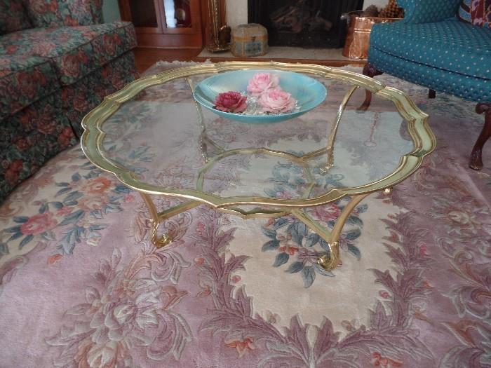 Gorgeous area rug and La Barge Hollywood Glam glass and brass oval coffee table