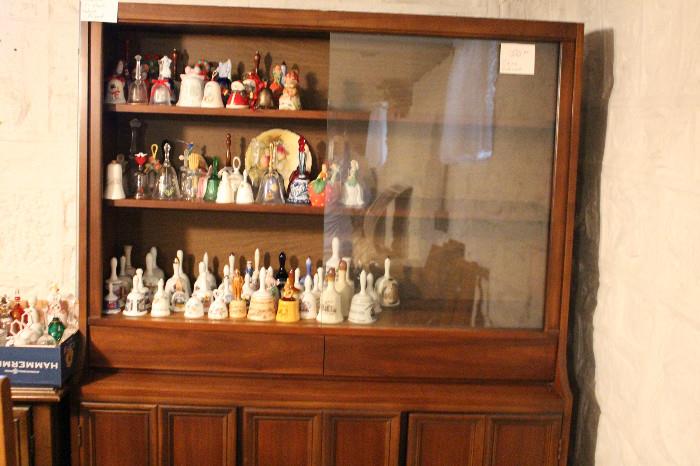 China cabinet filled with bell collection
