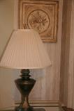 Closer shot of lamp and wall hanging