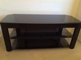 Black glass stand holds 50" TV