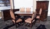 C/1935 Walnut European style Dining suite w/Blind China, Draw leaf rectangular table w/6 chairs (1 arm chair) and long Buffet w/ornate carvings and crotch cut walnut door panels 