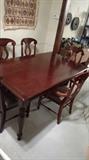 Awesome dining room set with table leaf, and drawers on each end, pineapple leg carvings...