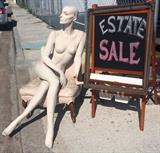 Our lady out front at gate with sign