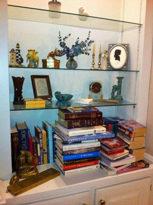 Some books, candleholders, clocks and trinkets.