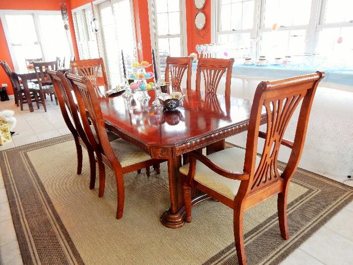 Cherry finish Dining Suite, Table is showing with one extension in it. has lighted china cabinet to match