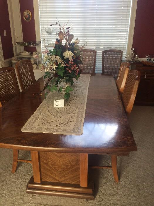 Large dining table has matching chairs, server, & china cabinet .