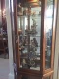 Curio cabinet with bird figurines