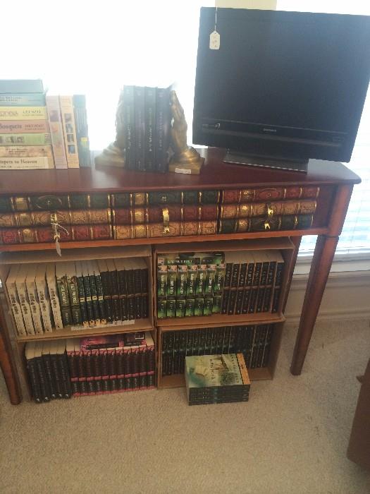 "Books" sofa table; praying hands book ends; Kathy Herman's books; flat screen TV