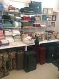 Many linens, suitcases,  and frames