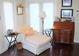 Upholstered chaise lounge, tray tables, nice floor lamp, and vintage desk